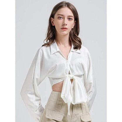 Elegant white vintage-inspired crop blouse with v-neck and long sleeves, a timeless and versatile wardrobe essential