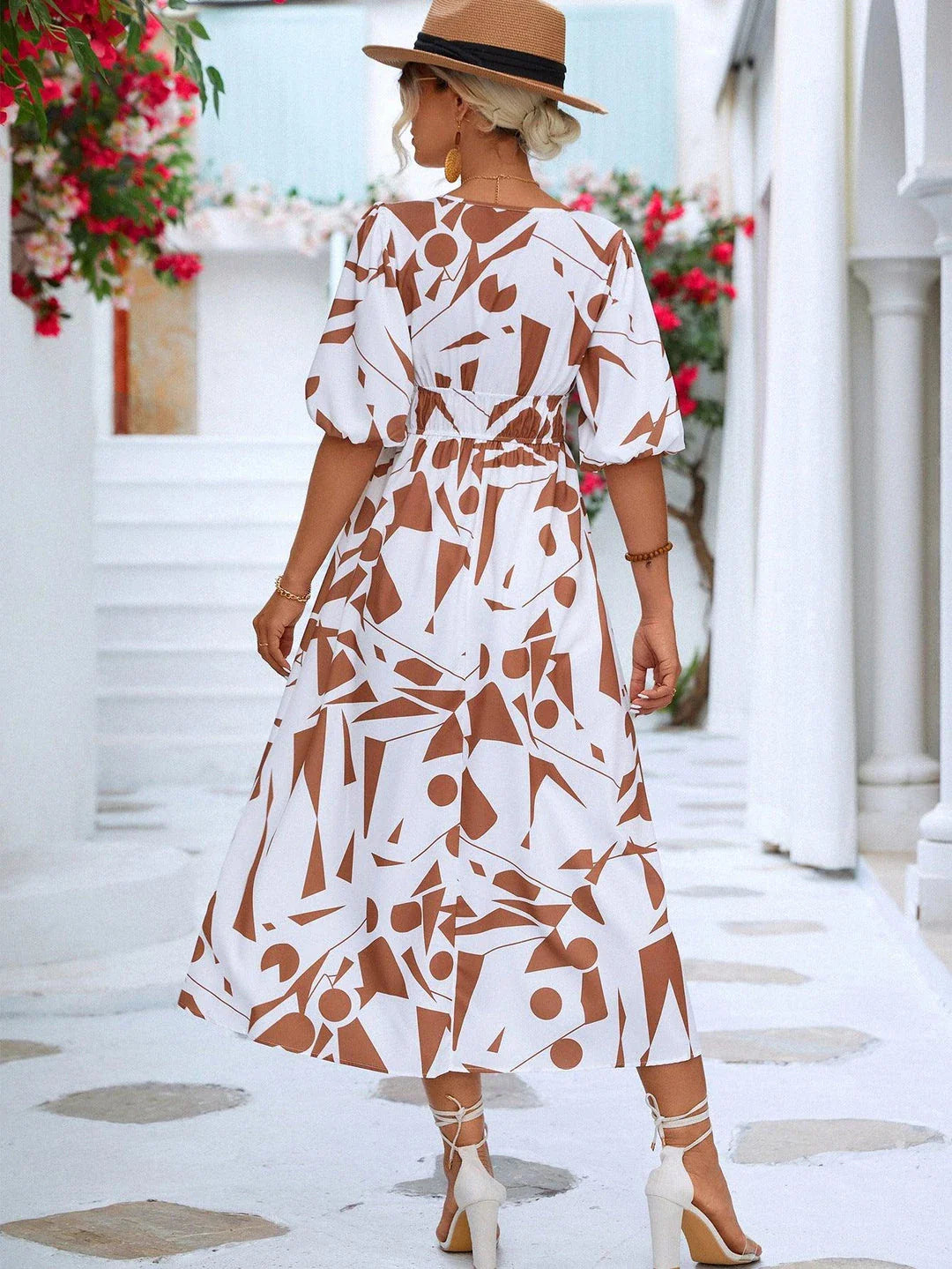 A stylish printed surplice dress with balloon sleeves, perfect for effortless elegance
