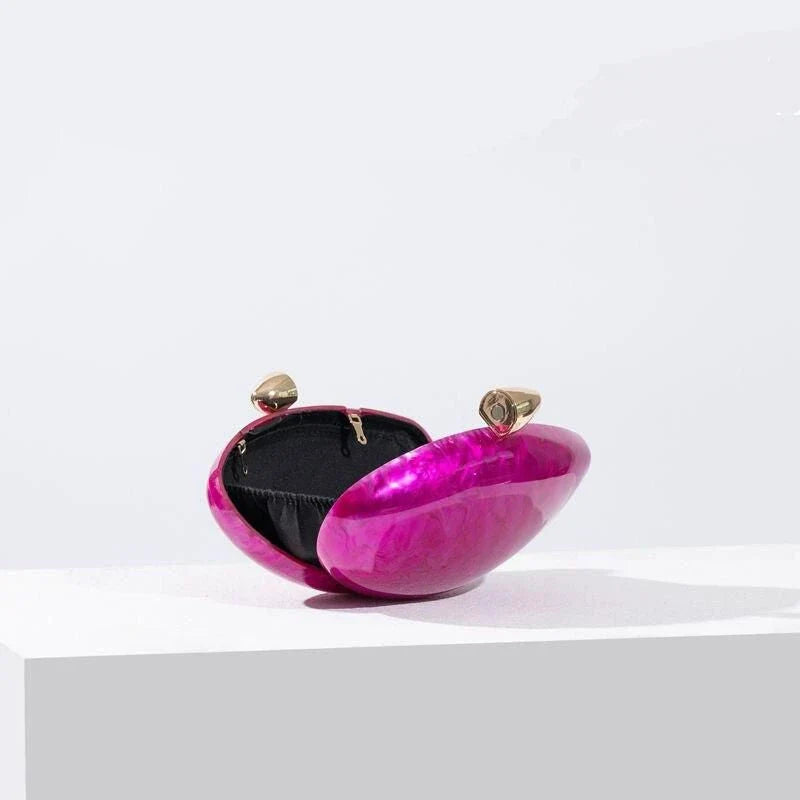 Elegant acrylic rose-colored clutch with delicate diamond-like decorations, perfect for formal events and special occasions.