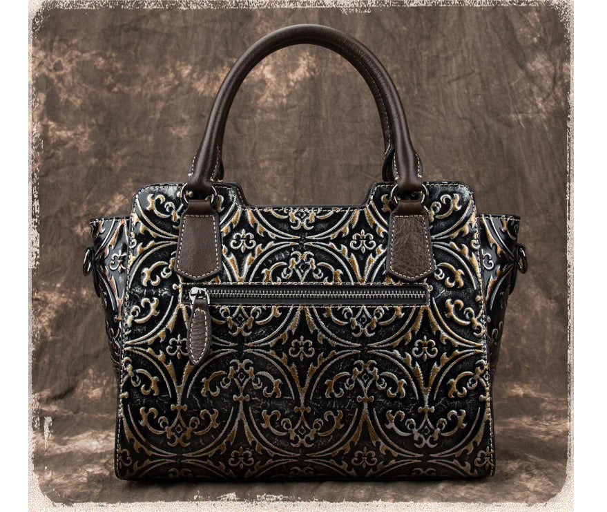 A fashionable large capacity leather shoulder bag for women in a vintage-inspired floral design with multiple interior pockets for organization.