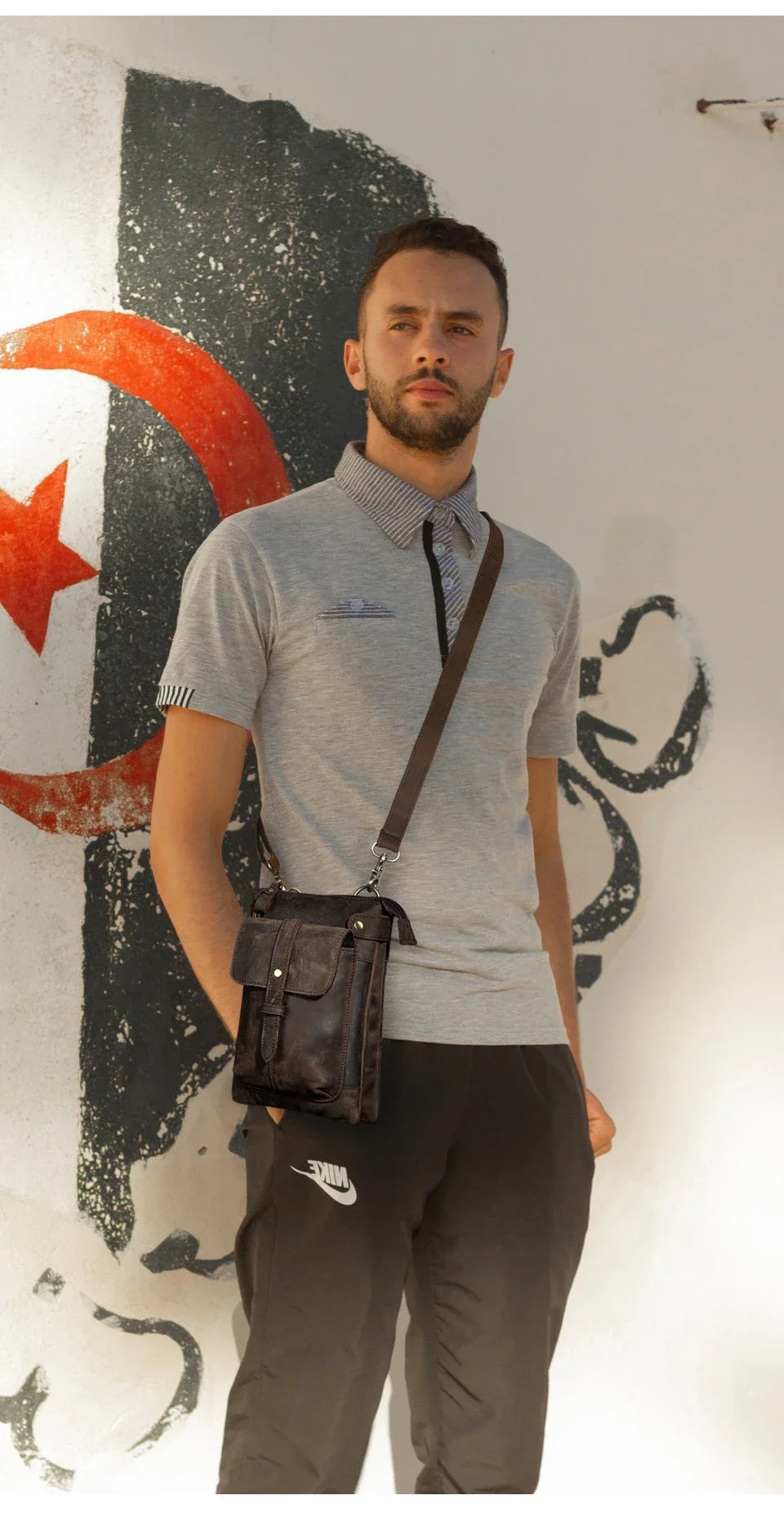 A premium cowhide leather shoulder bag with a compact and versatile design, suitable for various occasions and outdoor activities.