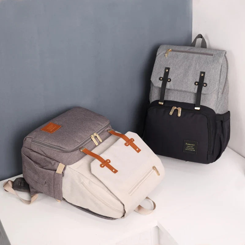 Premium diaper backpack with insulated pockets, stroller attachment, and USB charging port