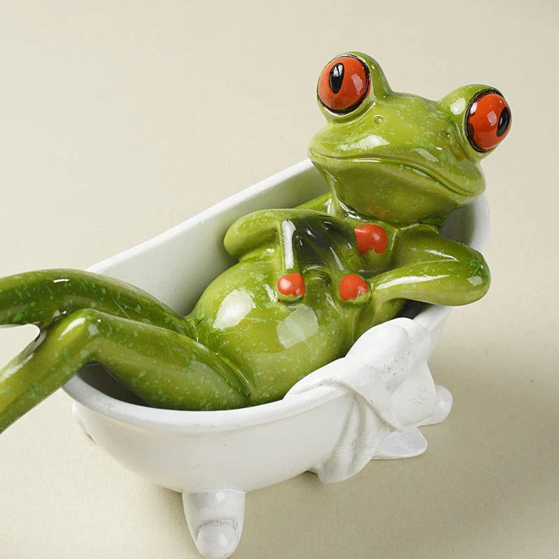 Resin frog figurines in a bathtub, adding a playful touch to bathroom decor