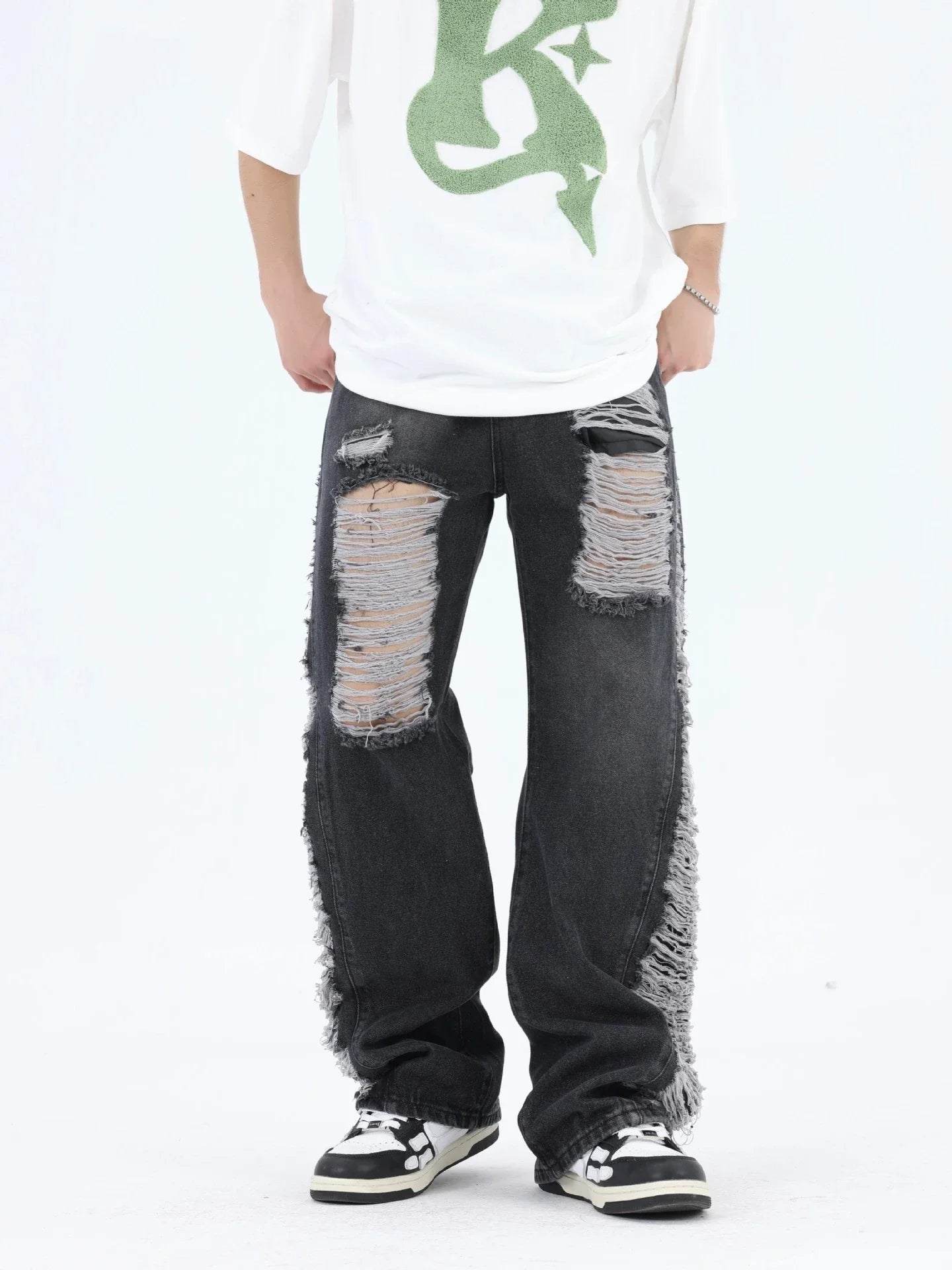 Premium loose fit distressed denim trousers for men and women, featuring a relaxed silhouette, high-quality cotton construction, and trendy distressed details.