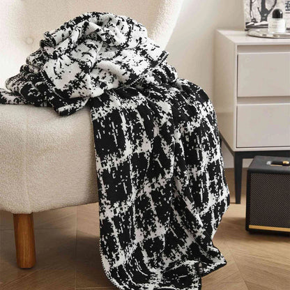 Luxurious white and black plaid wool knit blanket for cozy home, travel, and relaxation