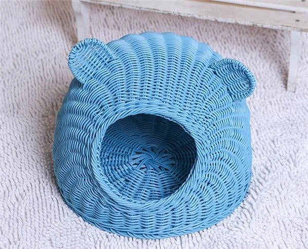 A cozy round woven pet bed made of premium wicker with a soft, plush interior for maximum comfort and style.