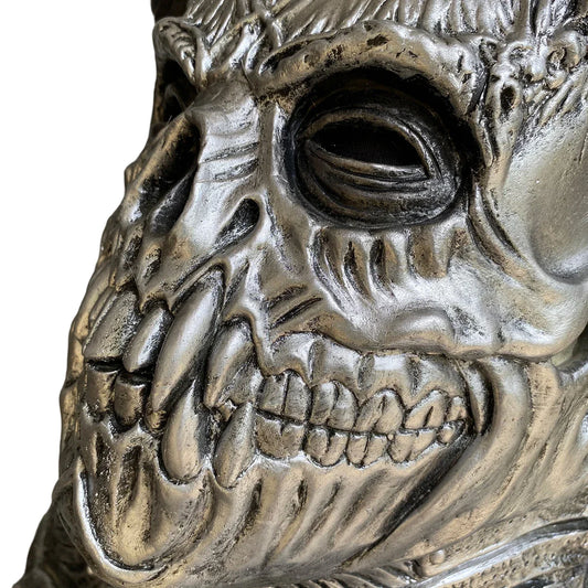 A terrifying Halloween mask made of latex, featuring a skull design with horns to create a dark, demonic appearance.