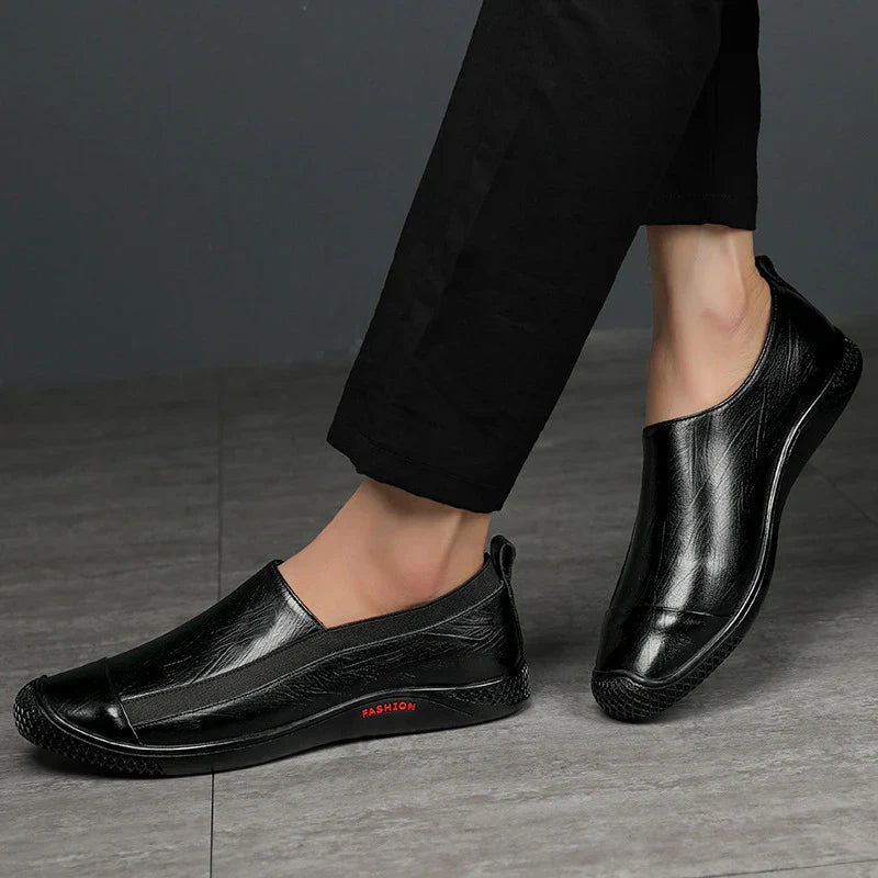 A pair of durable and stylish men's casual leather shoes in black, featuring a pointed toe, low upper, and rubber sole.