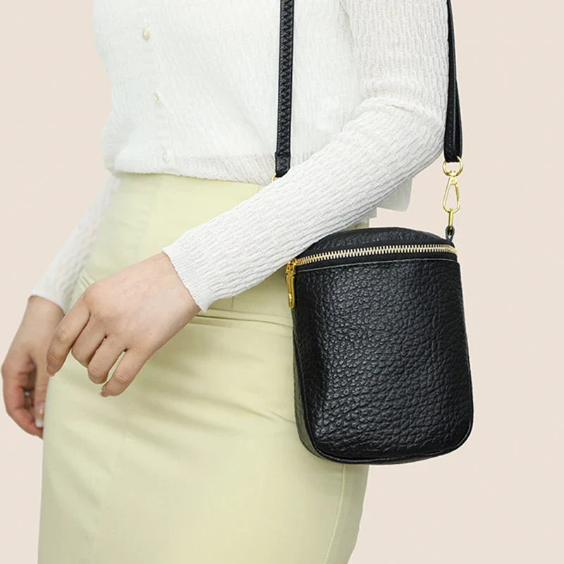 Premium leather crossbody bag with adjustable strap, multiple pockets, and sleek Korean-inspired style