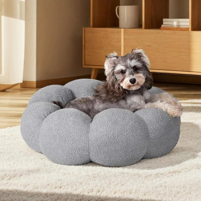 A cozy, flower-shaped dog bed made of soft, plush teddy sherpa fabric with raised edges for head and neck support, providing a calming and comfortable resting spot for medium-sized dogs.