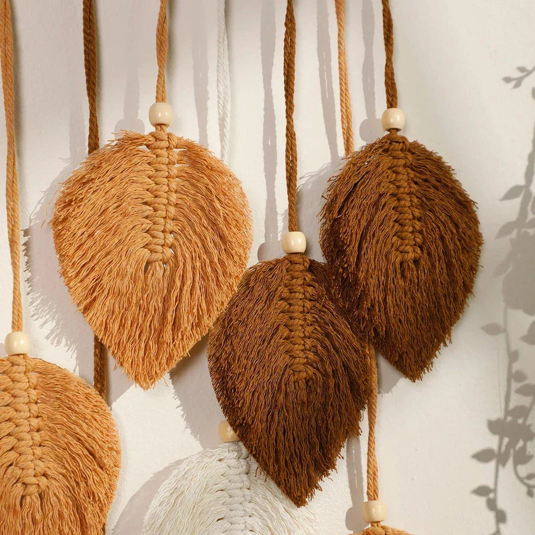 Boho macrame leaf tapestry in earthy tones, featuring elegant leaves and flowing tassels for a cozy, nature-inspired decor piece