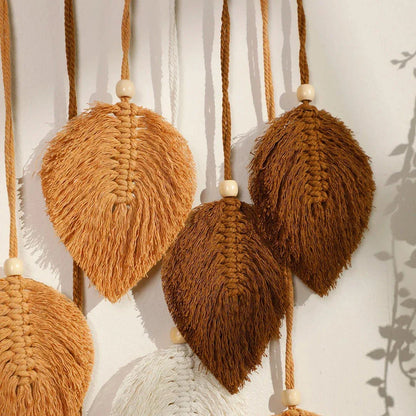 Boho macrame leaf tapestry in earthy tones, featuring elegant leaves and flowing tassels for a cozy, nature-inspired decor piece