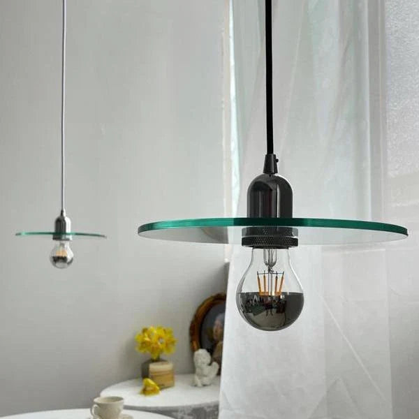 Elegant modern clear glass pendant light with a white shade, perfect for dining rooms and bedrooms