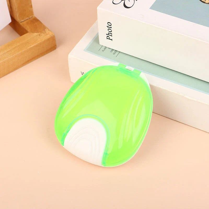 Compact, transparent dental retainer storage box with a push-to-open mechanism for easy access to dental appliances