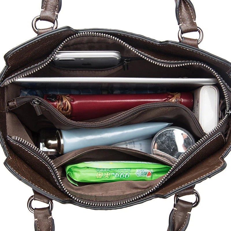 A fashionable large capacity leather shoulder bag for women in a vintage-inspired floral design with multiple interior pockets for organization.