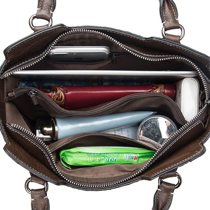 A fashionable large capacity leather shoulder bag for women in a vintage-inspired floral design with multiple interior pockets for organization.