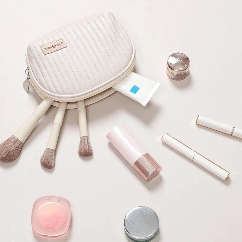 Stylish compact makeup bag made of premium PU leather in light blue color, with a sleek minimalist design for modern women