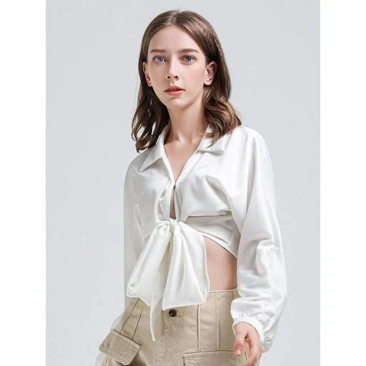Elegant white vintage-inspired crop blouse with v-neck and long sleeves, a timeless and versatile wardrobe essential