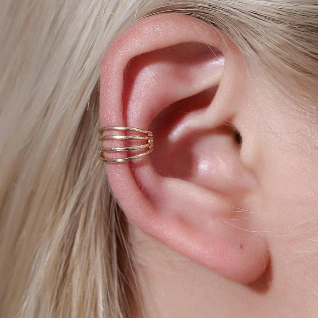Elegant multilayered ear cuff in a lustrous golden tone, offering a stylish and versatile accessory for chic looks.