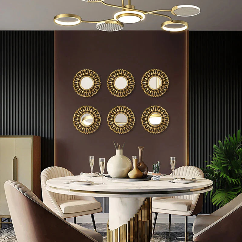 Elegant gold floral wall mirror with round design and metal frame, perfect for home decor