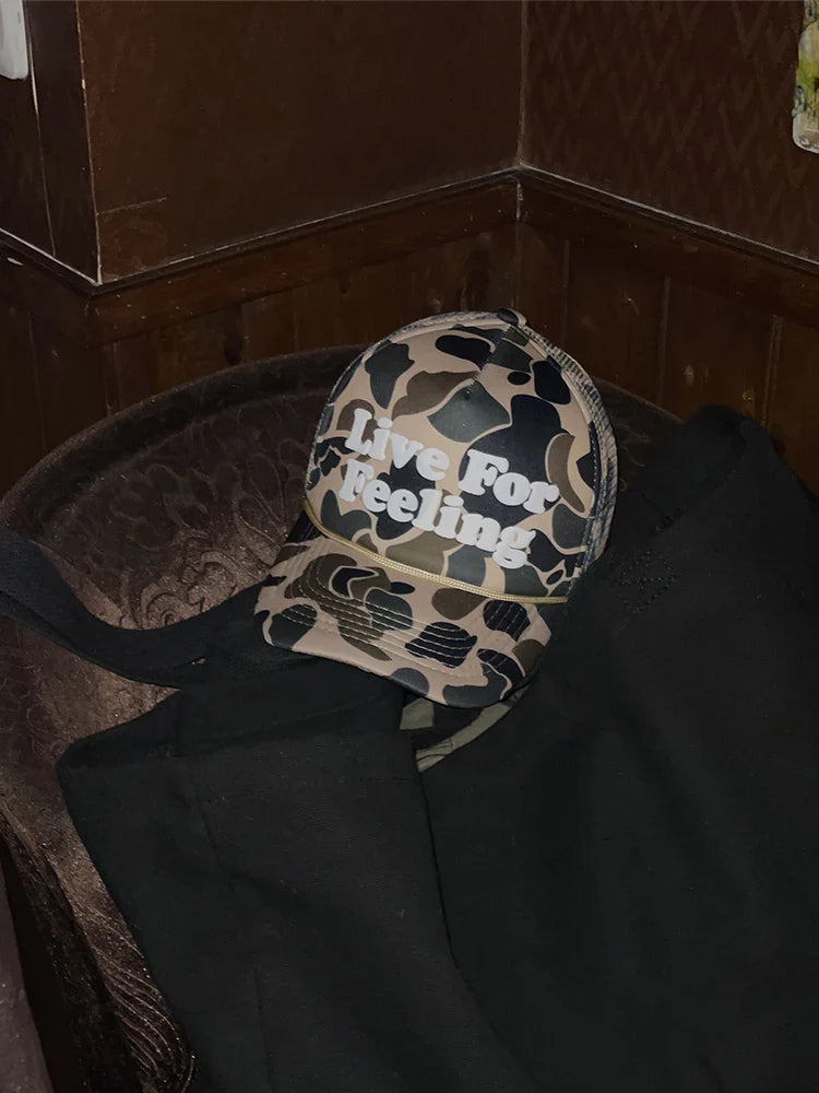 Camo curved brim hat with embroidered 'Live For Feeling' slogan, adjustable size for all-day comfort and style