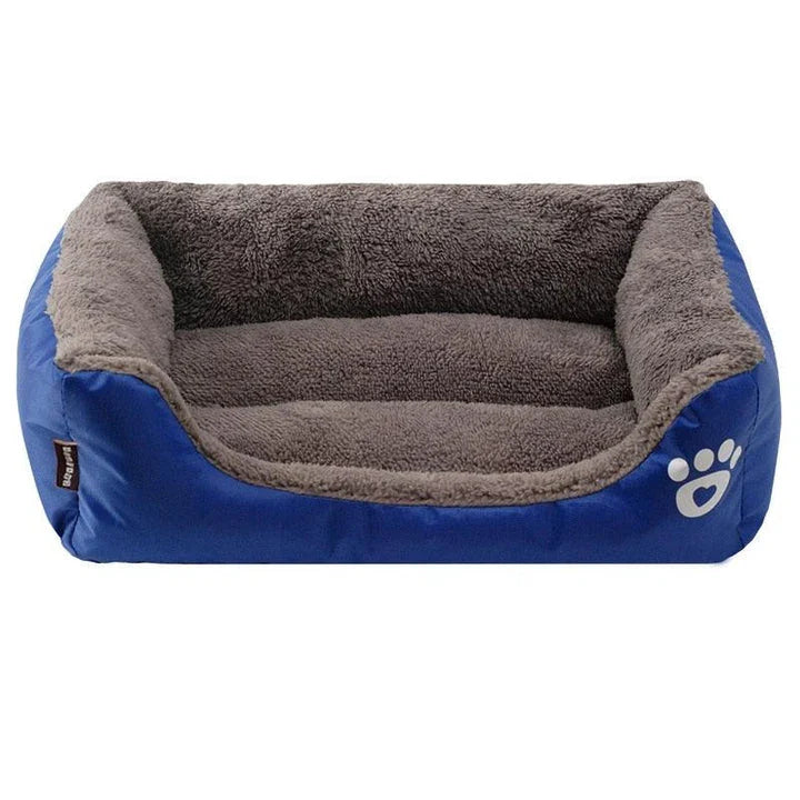 A plush, green pet bed with a paw-print pattern, designed to provide cozy and waterproof comfort for pets.