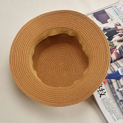 Classic straw Panama hat with a bow detail, offering sun protection and fashionable summer style