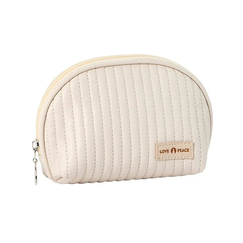Stylish compact makeup bag made of premium PU leather in light blue color, with a sleek minimalist design for modern women