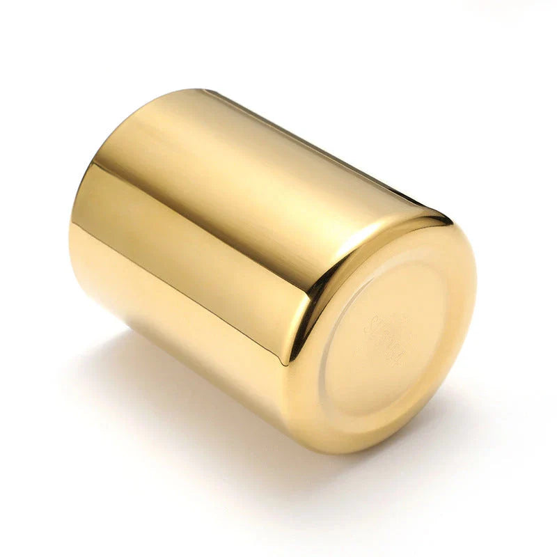 Elegant gold stainless steel desk organizer holding pens, pencils, and makeup brushes on a modern workspace