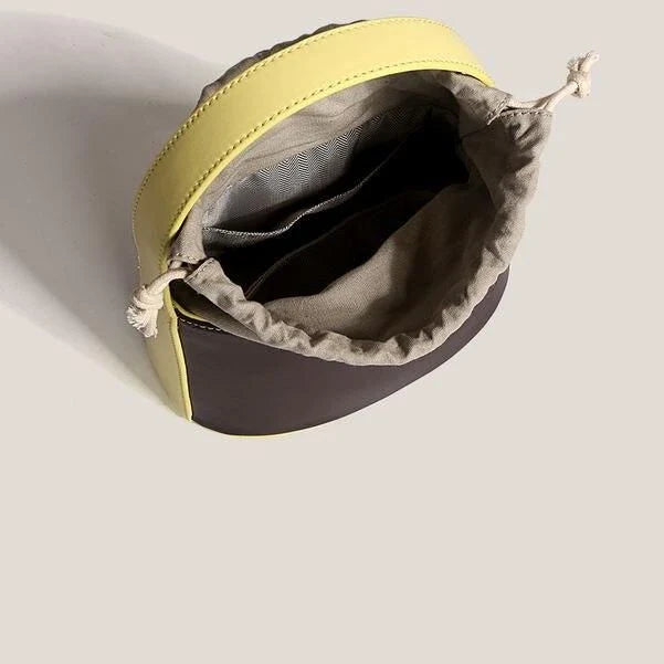 Chic color block vegan leather bucket bag with adjustable strap, perfect for everyday use and special occasions