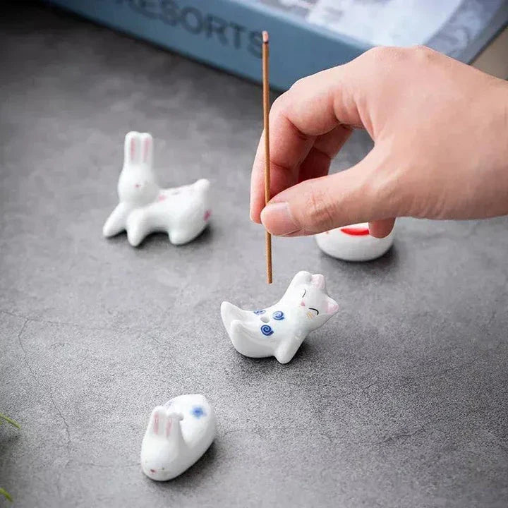 Charming ceramic incense holder featuring a cute rabbit and kitten design, perfect for adding a touch of whimsy and tranquility to any room.