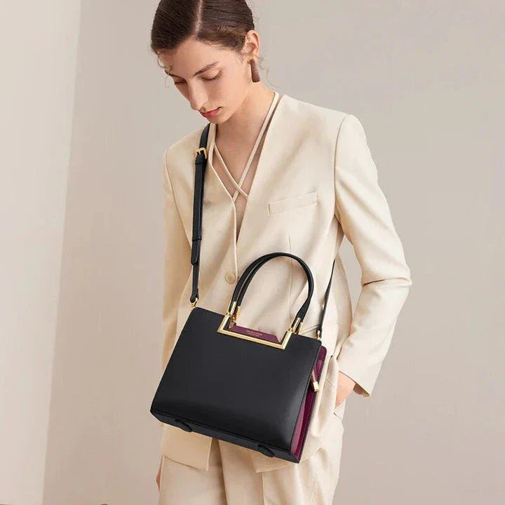 Elegant and spacious black leather tote bag with multiple compartments and a luxurious design