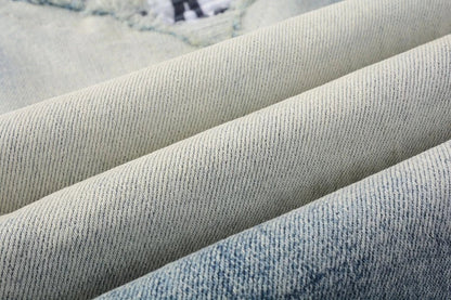 American High Street fashionable men's ripped black and white patch jeans in a light blue denim color