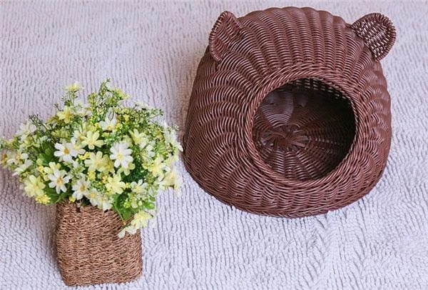 A cozy round woven pet bed made of premium wicker with a soft, plush interior for maximum comfort and style.