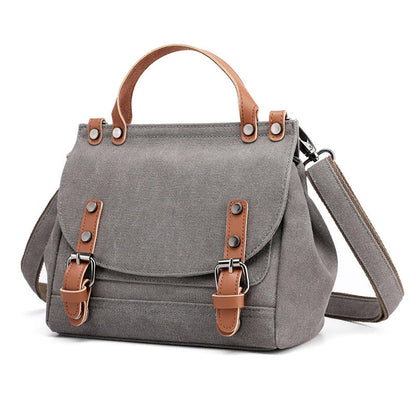 A stylish women's canvas crossbody handbag in an orange color, featuring a small square shape and a horizontal design.