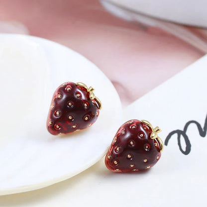 Fashionable red resin stereo strawberry stud earrings for women, featuring a captivating 3D illusion design