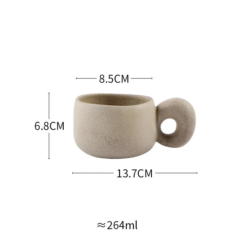 Handcrafted Japanese stoneware retro coffee mug in apricot and grey colors with a comfortable grip and minimalist design