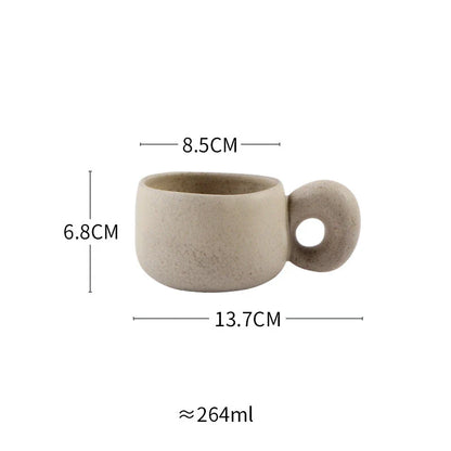 Handcrafted Japanese stoneware retro coffee mug in apricot and grey colors with a comfortable grip and minimalist design
