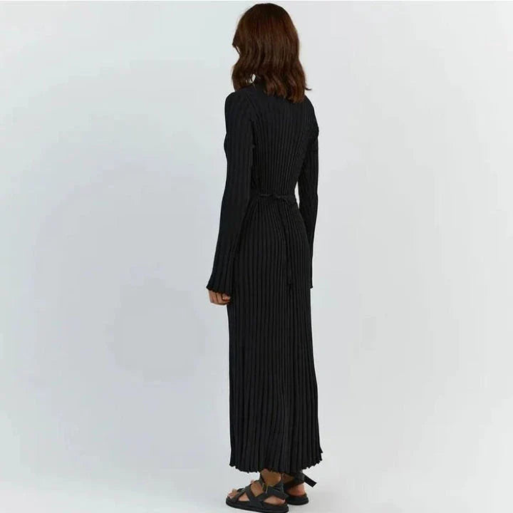 Timeless elegant pleated knit dress in black, perfect for summer office wear with a sophisticated and comfortable design.