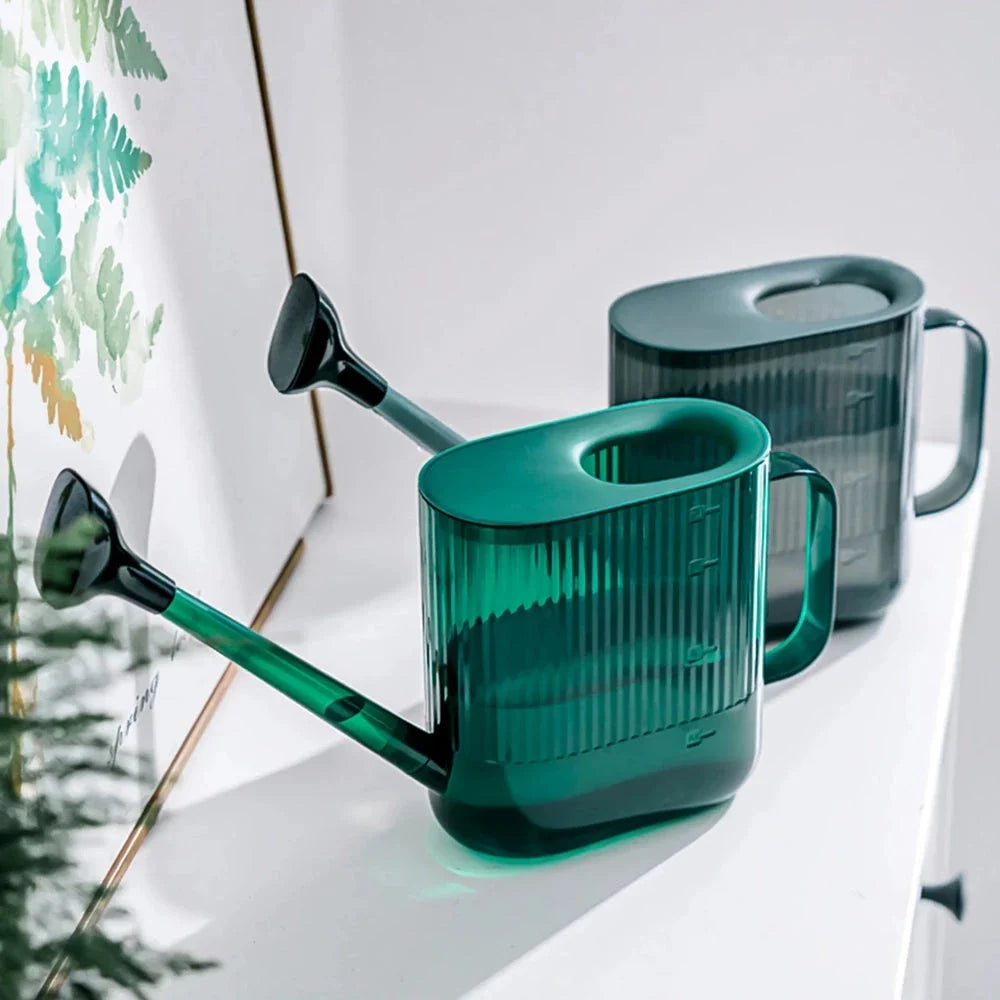 A large, dark grey gardening watering can with a long spout and sprinkler head for efficient, hassle-free plant watering