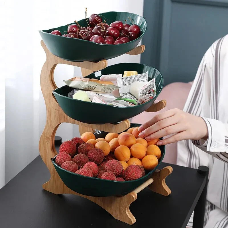 Three-tier plastic and bamboo fruit display tray with unique leaf-shaped design, available in white, beige, and green colors