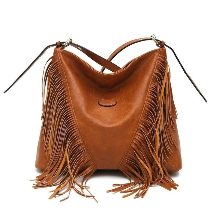 Chic vegan leather shoulder bag with tassel decoration, featuring a spacious interior and versatile carrying options
