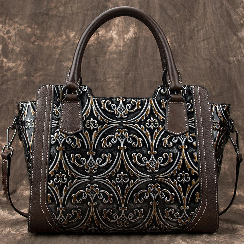 A fashionable large capacity leather shoulder bag for women in a vintage-inspired floral design with multiple interior pockets for organization.