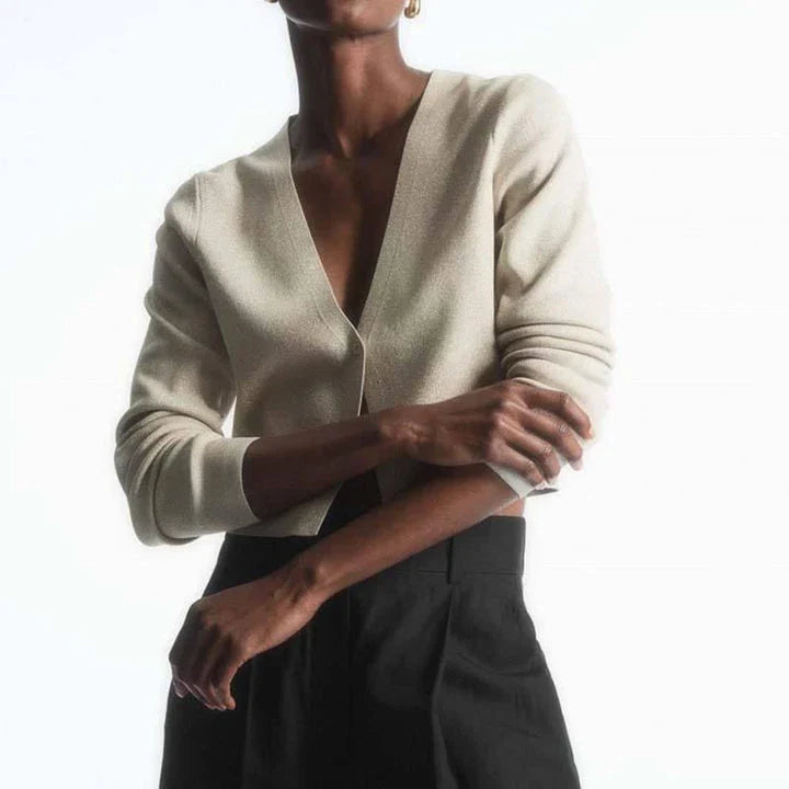 A cozy and chic v-neck cardigan in a classic solid color, featuring a slim, flattering fit and elegant button detailing for versatile autumn and winter wear.
