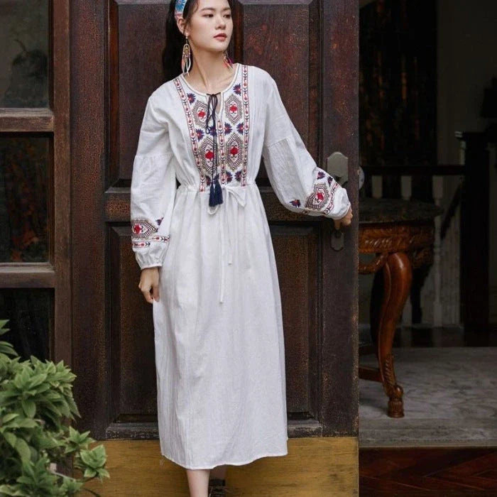 Elegant embroidered cotton-linen dress with tassels, featuring a waist-cinching A-line silhouette in vibrant colors