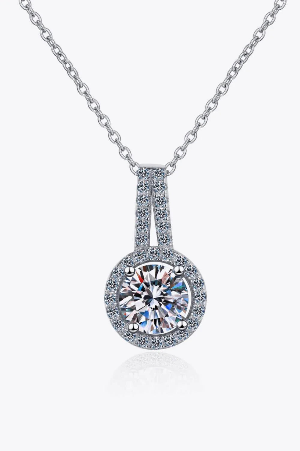 A sterling silver necklace with a round moissanite stone pendant, showcasing a sparkling and elegant design.