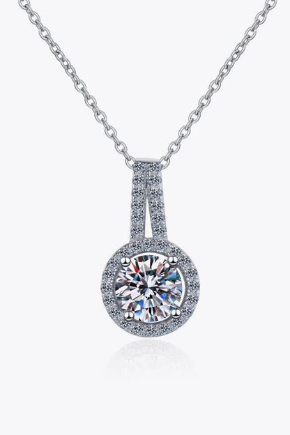 A sterling silver necklace with a round moissanite stone pendant, showcasing a sparkling and elegant design.
