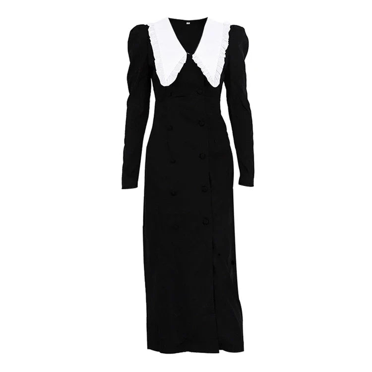 Black and white color-blocked dress with long sleeves and a doll collar, showcasing a timeless and sophisticated style.