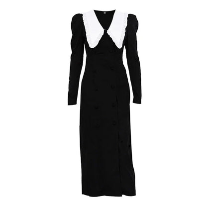 Black and white color-blocked dress with long sleeves and a doll collar, showcasing a timeless and sophisticated style.