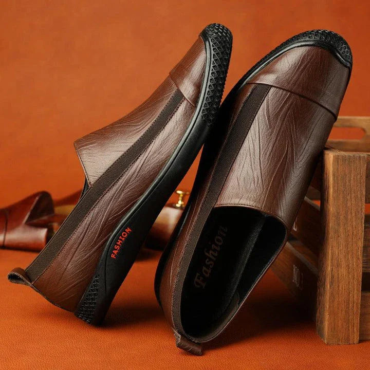 A pair of durable and stylish men's casual leather shoes in black, featuring a pointed toe, low upper, and rubber sole.